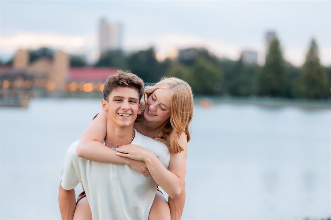 Young couple laughing beside a lake