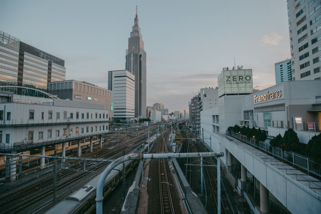 Rail lines leading through a dense Tokyo cityscape